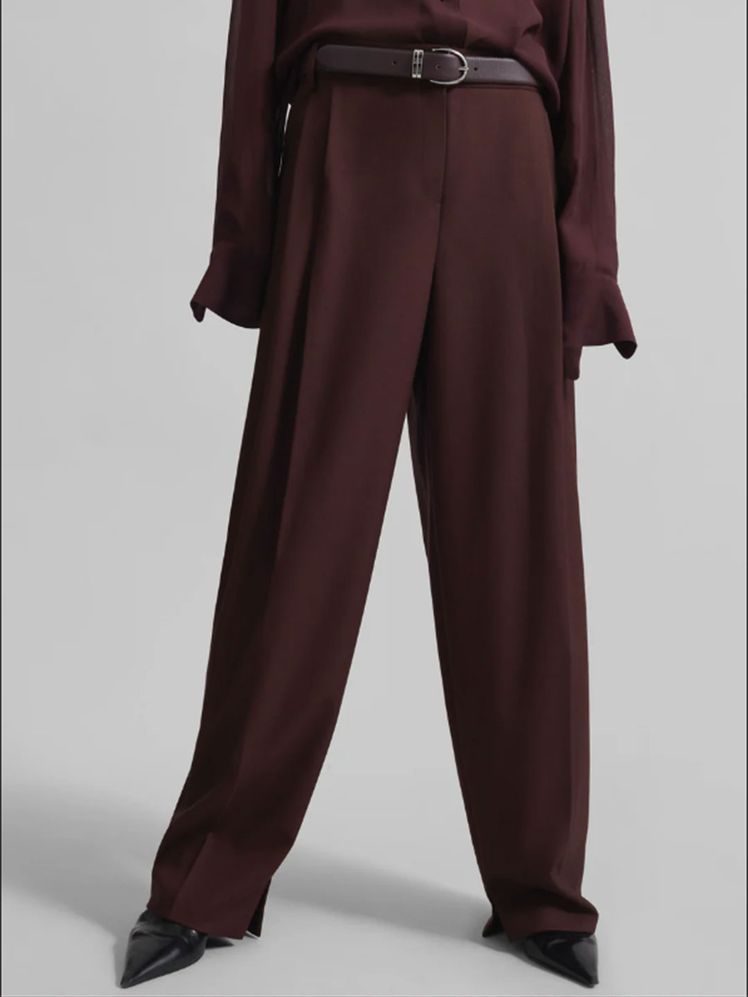 Image may contain Clothing Formal Wear Suit Pants Maroon Adult and Person