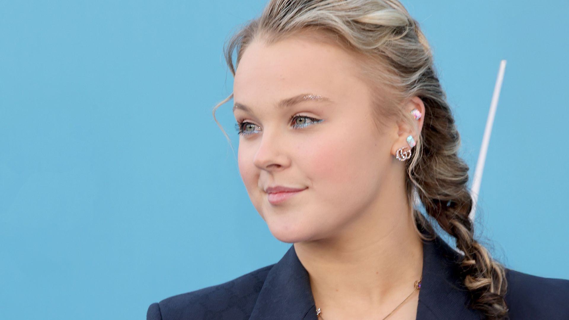 Image may contain JoJo Siwa Accessories Earring Jewelry Face Head Person Photography Portrait Adult and Necklace