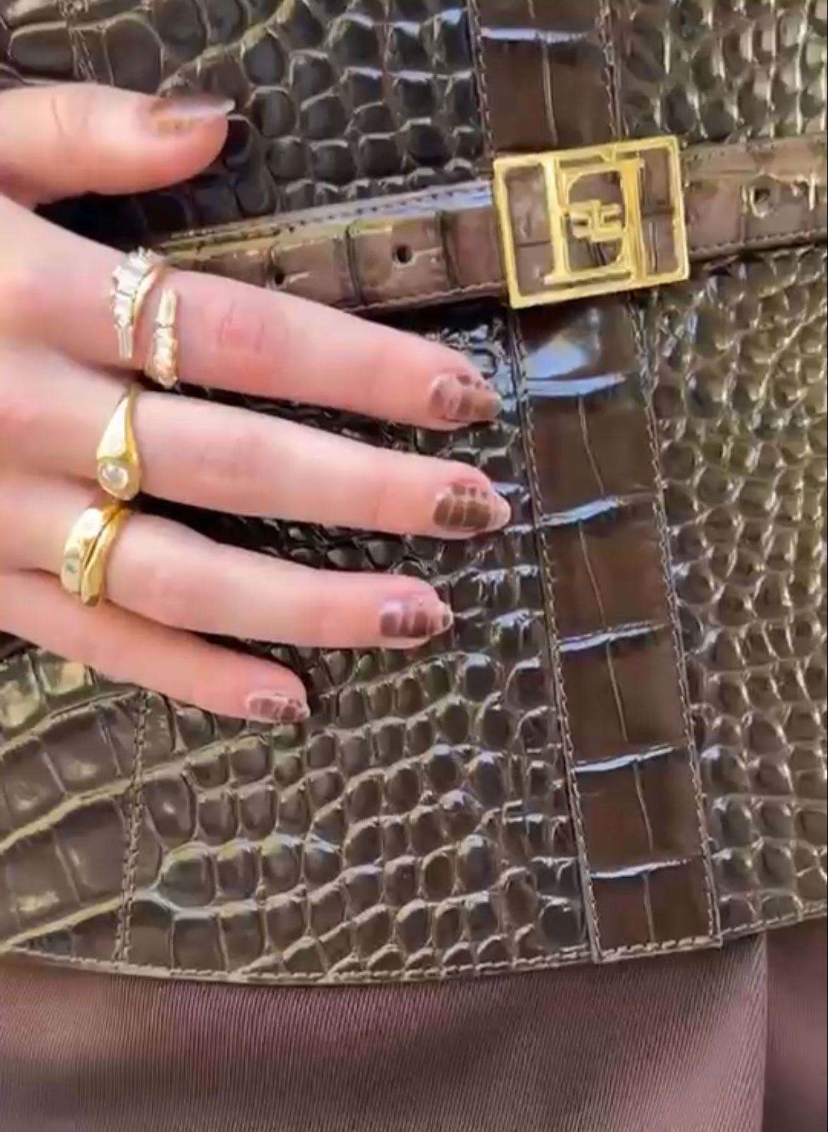 Sydney Sweeney wears brown crocodile nails that match her belt.